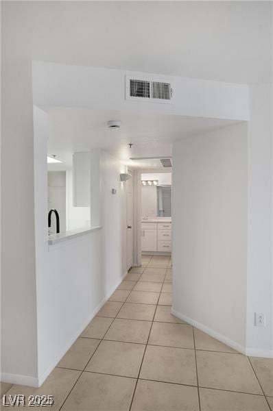 corridor featuring light tile patterned floors