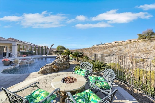 view of pool with pool water feature, a patio area, an in ground hot tub, and an outdoor fire pit