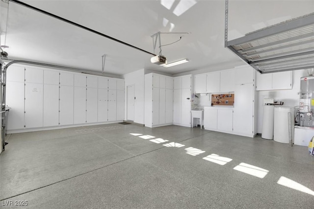 garage featuring strapped water heater and a garage door opener