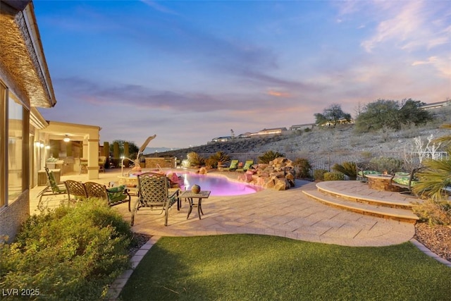 yard at dusk featuring a patio area