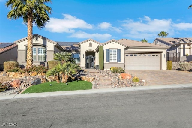 view of front of property featuring a garage and solar panels