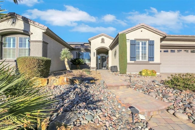 view of front of house featuring solar panels and a garage