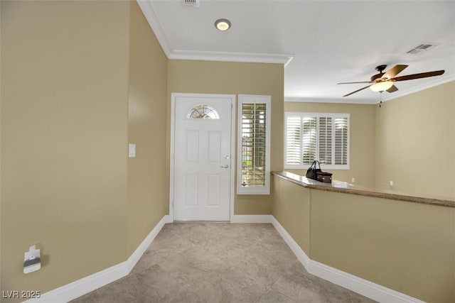 entryway with ceiling fan and ornamental molding