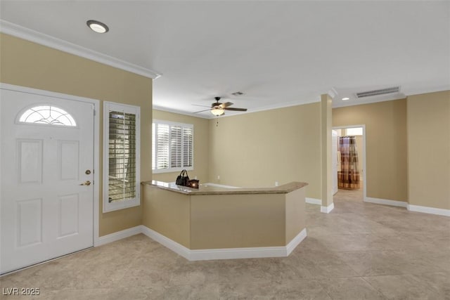 entryway featuring ceiling fan and crown molding