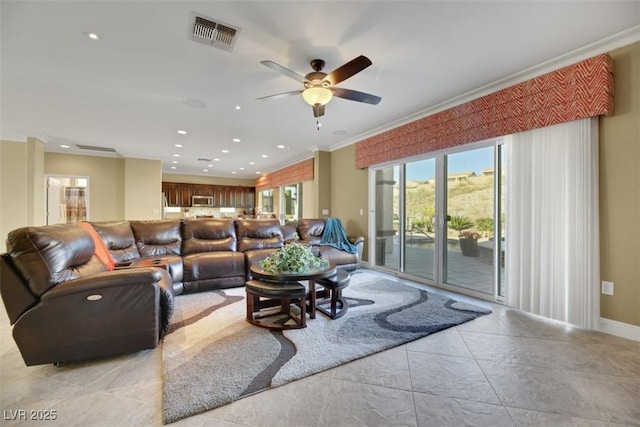 living room featuring ceiling fan and ornamental molding