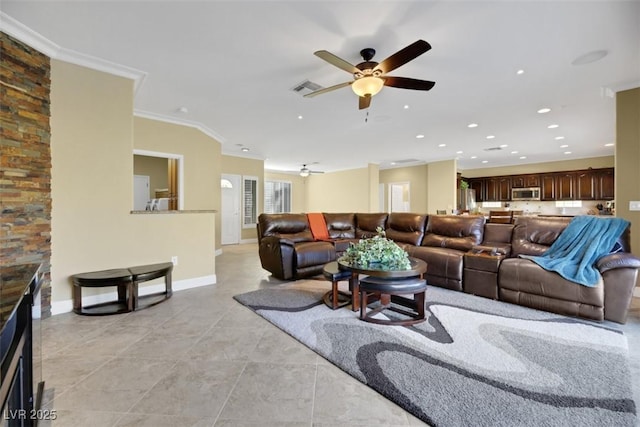 tiled living room featuring ceiling fan and ornamental molding