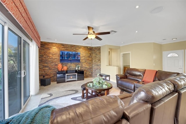 living room with ceiling fan and ornamental molding