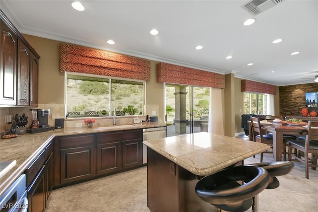 kitchen with sink, stainless steel dishwasher, dark brown cabinets, and ornamental molding