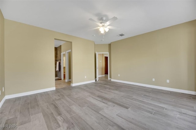 spare room featuring ceiling fan and light hardwood / wood-style flooring