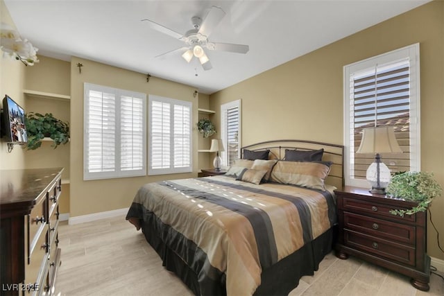 bedroom with ceiling fan and light hardwood / wood-style floors