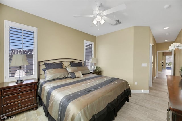 bedroom with ceiling fan and light hardwood / wood-style flooring