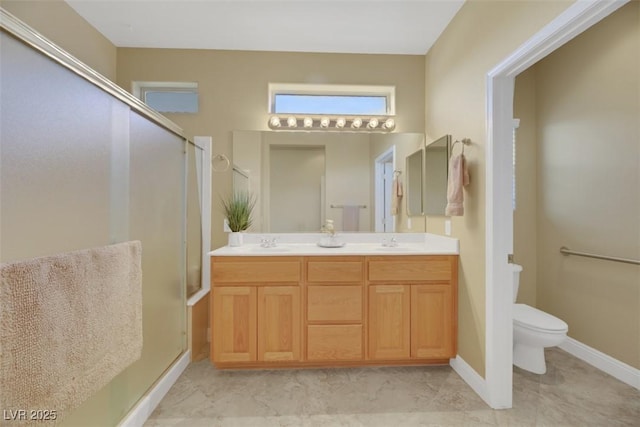 bathroom featuring vanity, toilet, and walk in shower