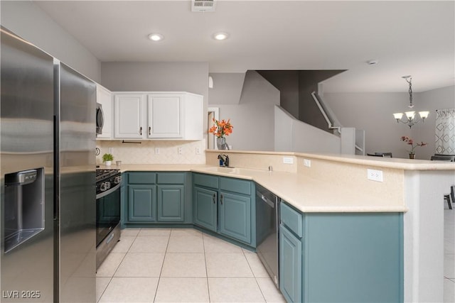 kitchen featuring kitchen peninsula, decorative backsplash, black appliances, decorative light fixtures, and white cabinetry