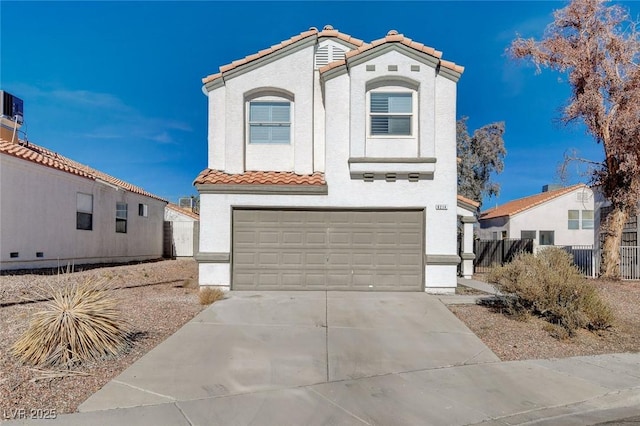 mediterranean / spanish-style home with a garage