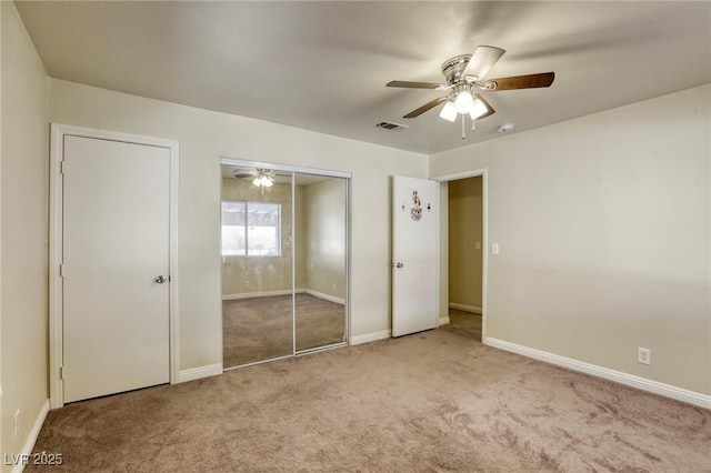 unfurnished bedroom featuring light colored carpet and ceiling fan