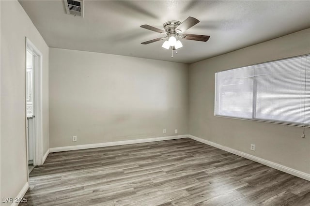 unfurnished room with ceiling fan and hardwood / wood-style floors