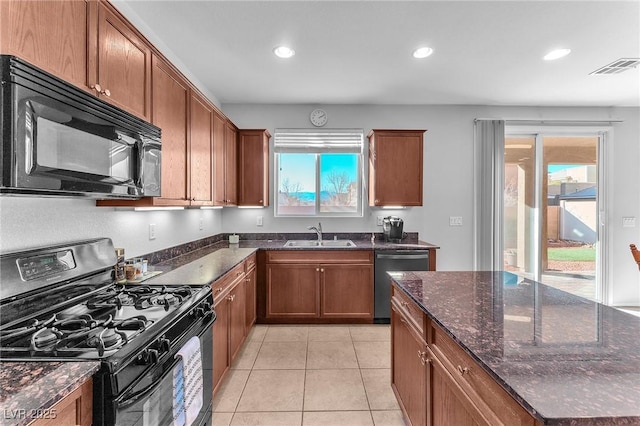 kitchen featuring sink, a wealth of natural light, and black appliances