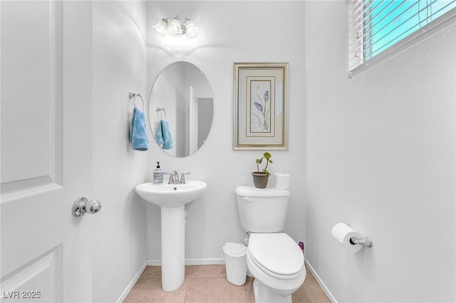 bathroom with tile patterned flooring, toilet, and sink