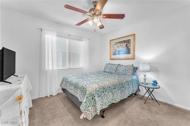 bedroom featuring ceiling fan and light carpet