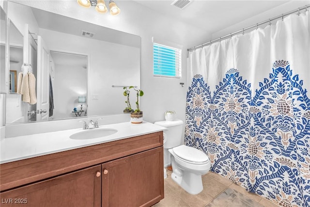 bathroom with tile patterned floors, vanity, and toilet