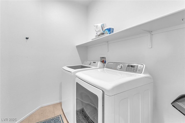 laundry area with light tile patterned floors and washing machine and dryer