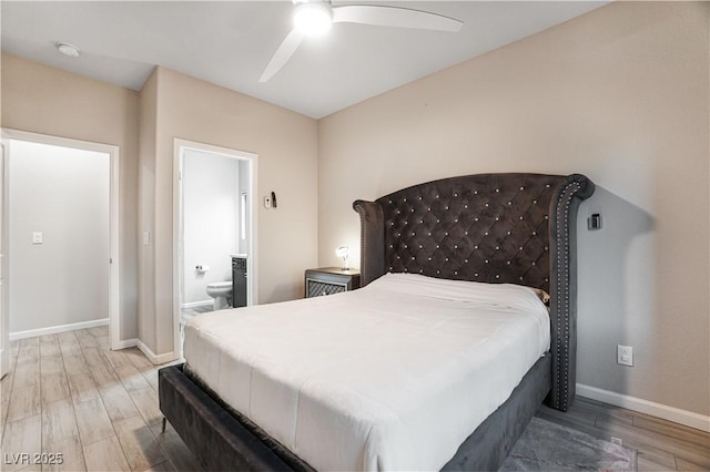 bedroom featuring hardwood / wood-style flooring, ceiling fan, and connected bathroom