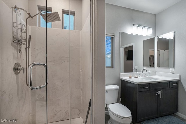 bathroom with walk in shower, vanity, and toilet