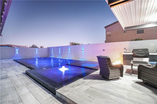 patio terrace at dusk featuring an in ground hot tub