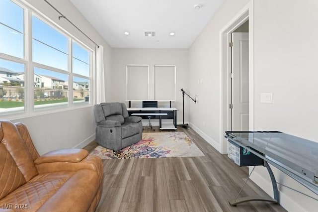 interior space with visible vents, baseboards, wood finished floors, and recessed lighting