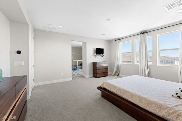 bedroom featuring light carpet, visible vents, and baseboards