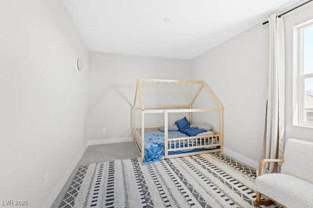 bedroom featuring carpet flooring and baseboards