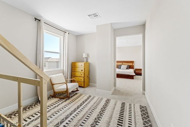 sitting room with light carpet, baseboards, and visible vents