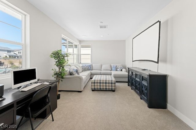 living area with light carpet and baseboards