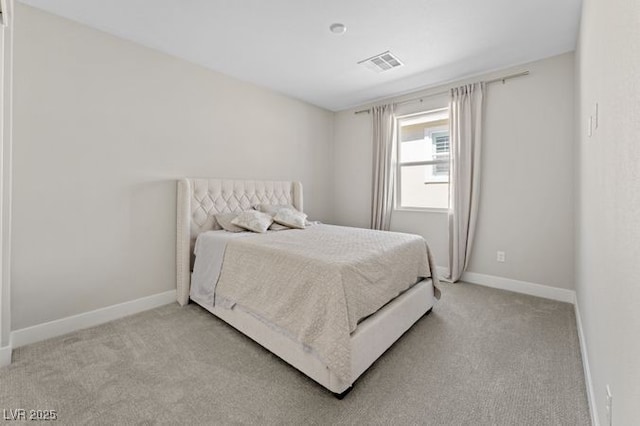 bedroom with baseboards, visible vents, and light colored carpet