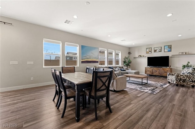 dining space featuring baseboards, wood finished floors, visible vents, and recessed lighting