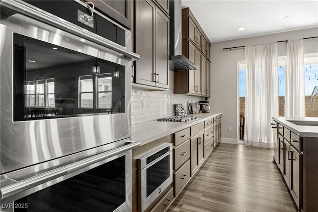 kitchen with light countertops, appliances with stainless steel finishes, and a healthy amount of sunlight