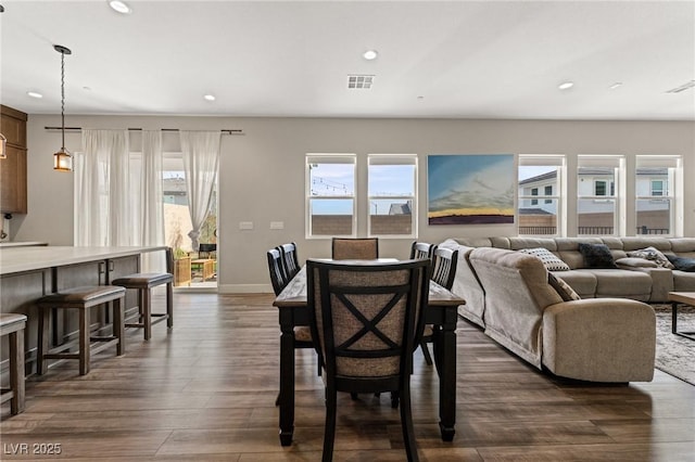 dining space featuring recessed lighting, a healthy amount of sunlight, visible vents, and dark wood finished floors