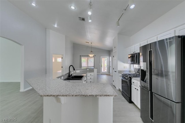 kitchen with black range with gas stovetop, sink, pendant lighting, white cabinets, and stainless steel fridge with ice dispenser