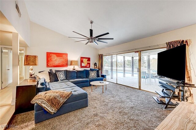 living room with carpet flooring, vaulted ceiling, and ceiling fan