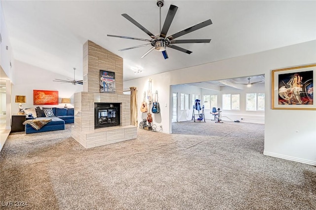 carpeted living area featuring baseboards, vaulted ceiling, a ceiling fan, and a tile fireplace