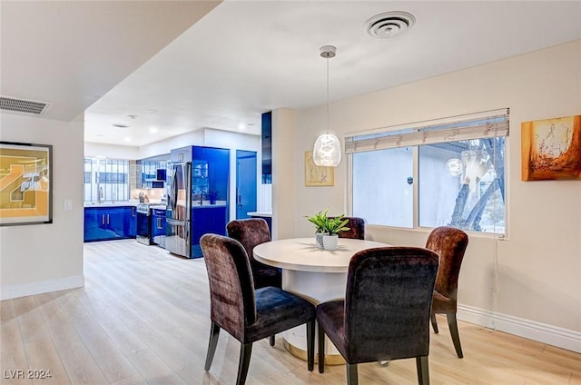 dining space with light hardwood / wood-style floors