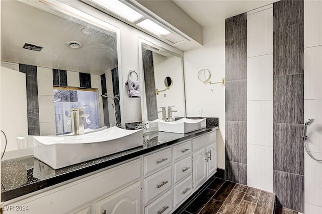 full bathroom featuring a sink, visible vents, and double vanity