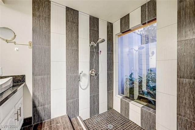 bathroom with vanity and tiled shower