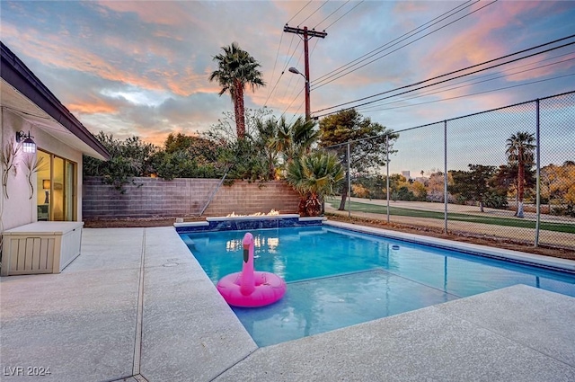 view of pool at dusk