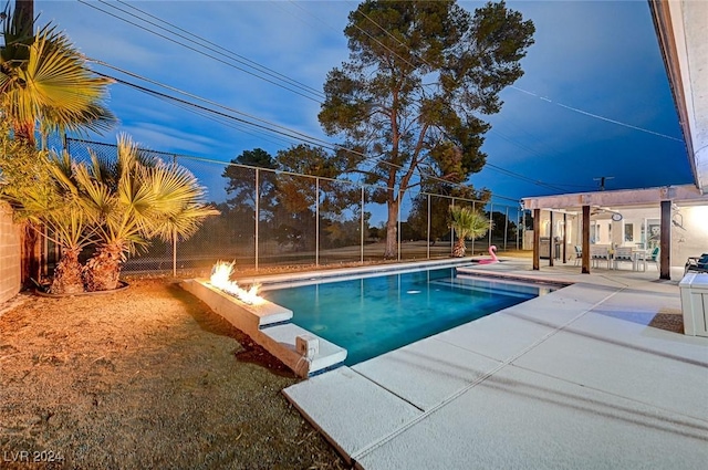 view of swimming pool with a patio area and an outdoor fire pit