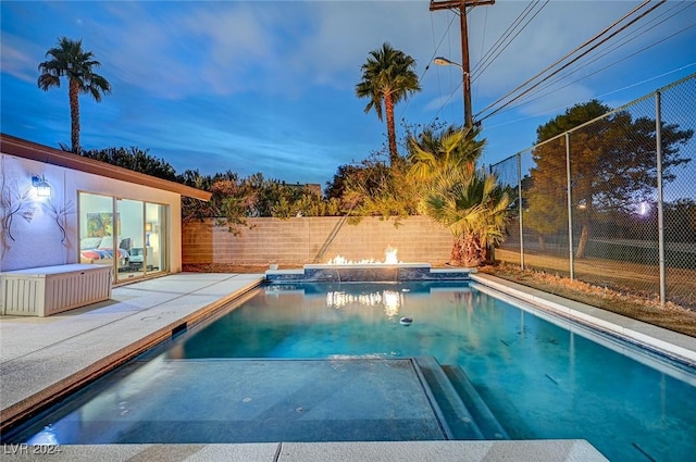 view of pool at dusk