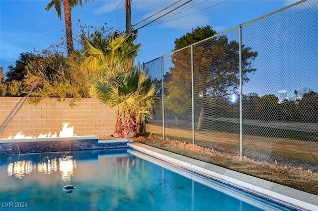 view of pool featuring fence
