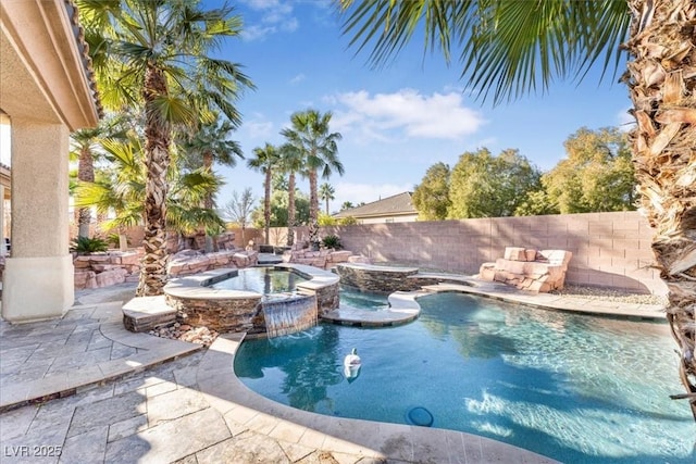 view of swimming pool with pool water feature, an in ground hot tub, and a patio