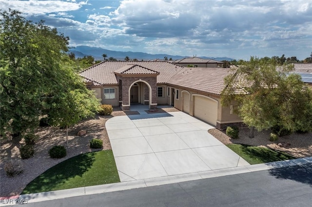 mediterranean / spanish home with a mountain view and a garage