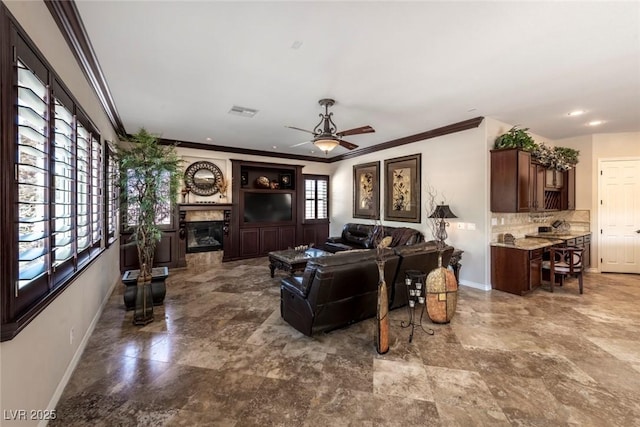 living room featuring crown molding, ceiling fan, and a healthy amount of sunlight